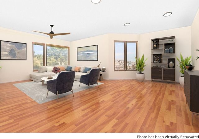 a living room with furniture window and wooden floor