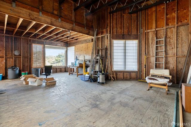 a view of a room with gym equipment and large window