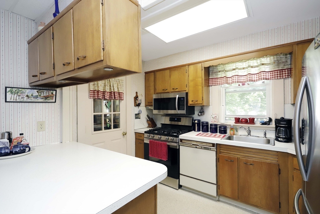 5 Anthony Street Acushnet, MA 02743 - Photo 23 of 37 a kitchen with stainless steel appliances a stove a sink dishwasher and a microwave