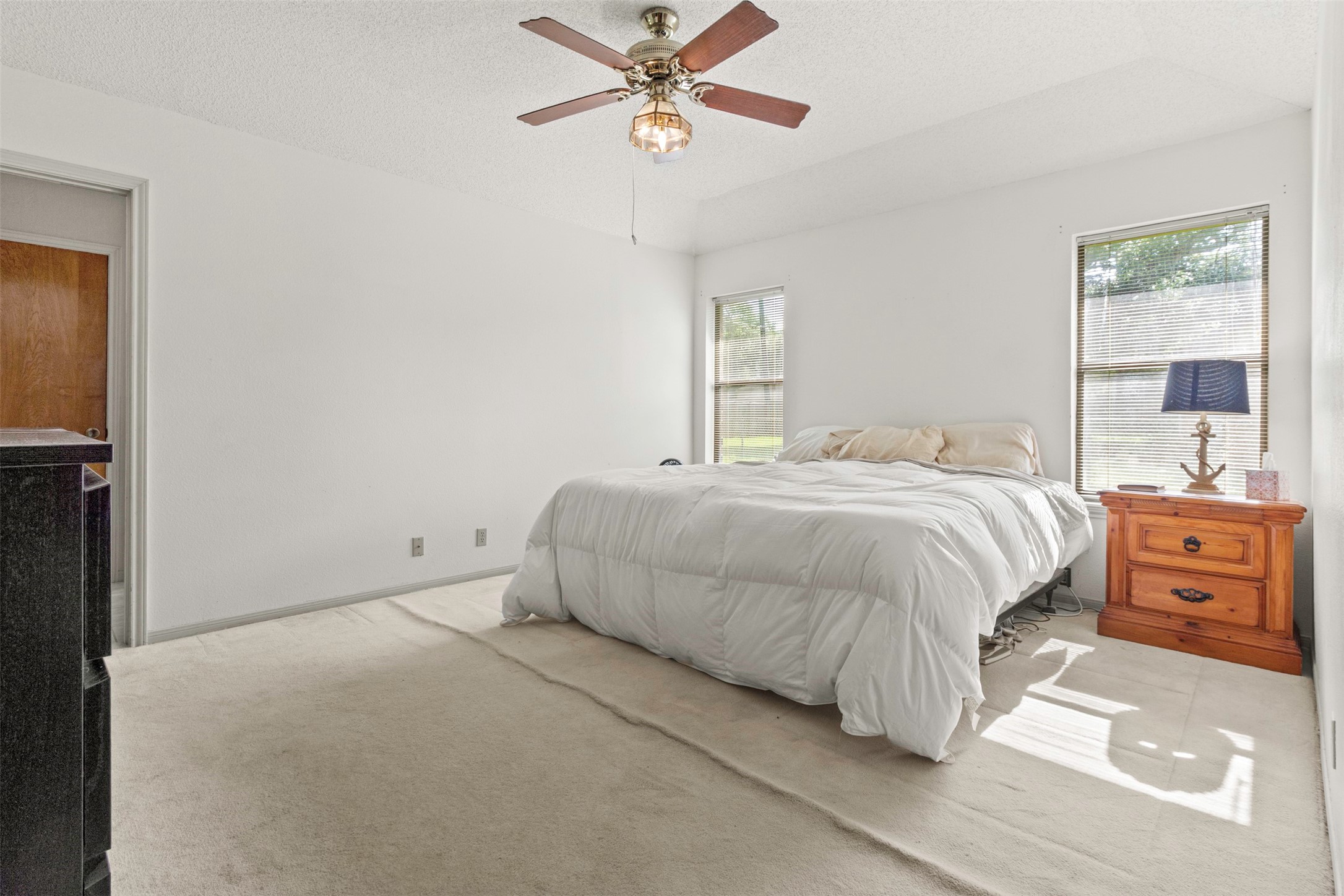 206 Stanford Road Lake Jackson, TX 77566 - Photo 9 of 26 a bedroom with a bed and a chandelier