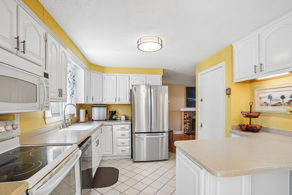 35 Westgate Road Framingham, MA 01701 - Photo 12 of 37 a kitchen with stainless steel appliances a stove a sink and a refrigerator