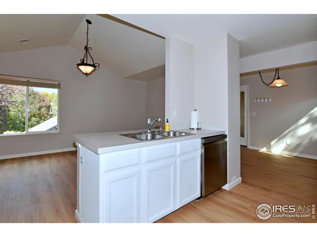 a kitchen with a sink and chandelier