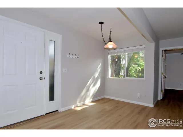 a view of an entryway in a hall with a window