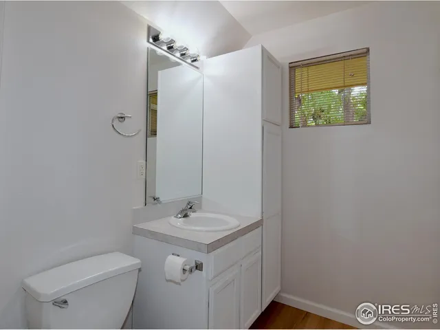 a bathroom with a sink mirror and toilet