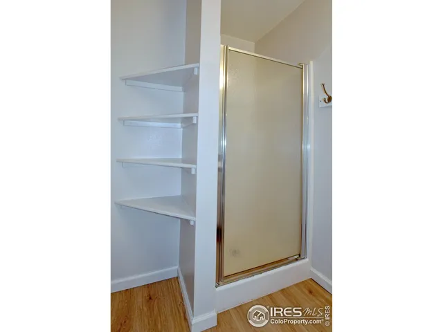 a view of a room with a door open and a microwave