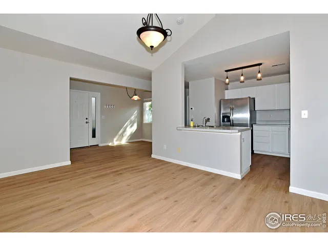 a view of a kitchen and an empty room