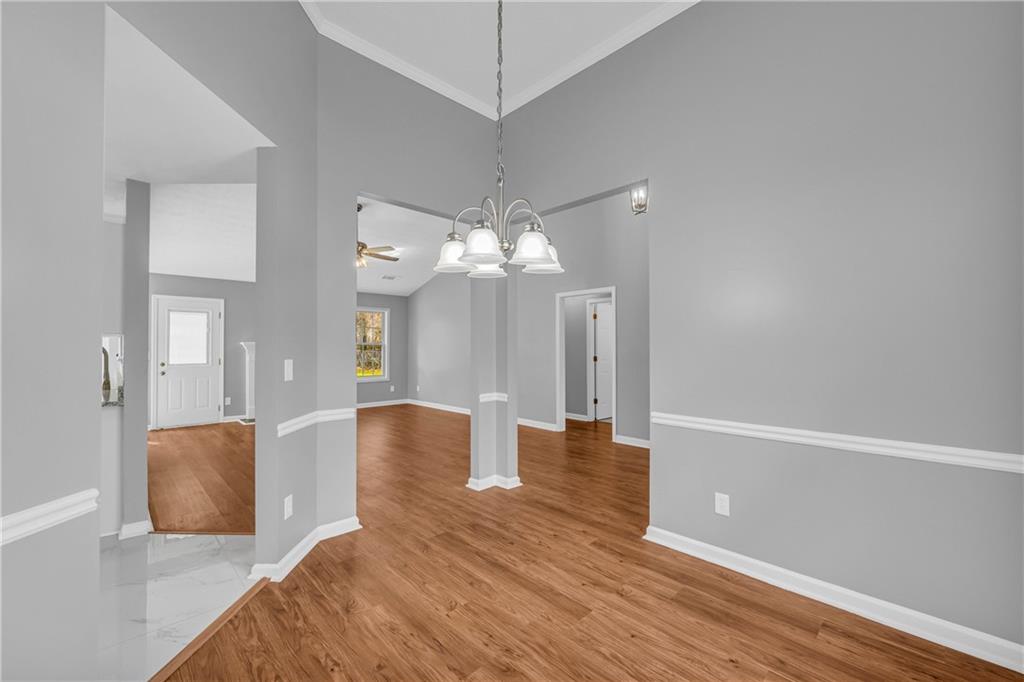 47 Chatham Court Jefferson, GA 30549 - Photo 21 of 69 a view of a livingroom with a fireplace a chandelier fan and wooden floor