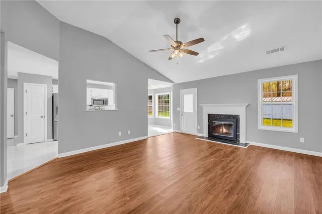 an empty room with closet and fan