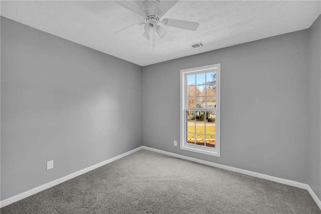 47 Chatham Court Jefferson, GA 30549 - Photo 27 of 69 an empty room with a window and a ceiling fan