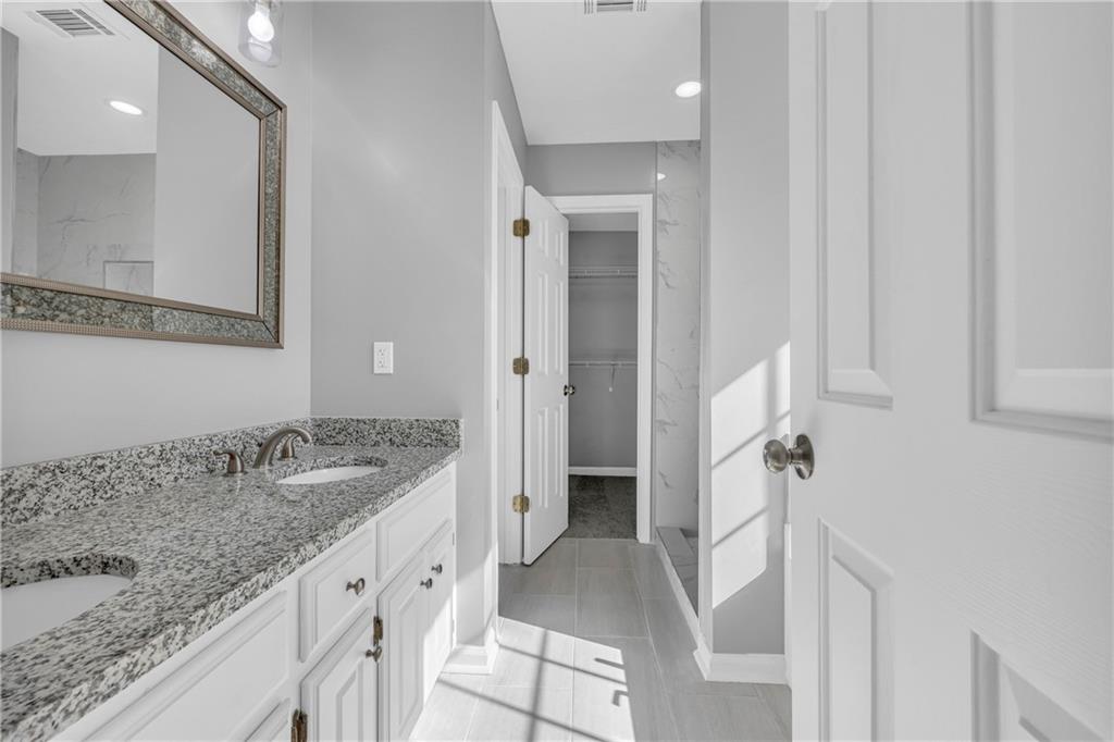 47 Chatham Court Jefferson, GA 30549 - Photo 46 of 69 a bathroom with a granite countertop sink and a mirror