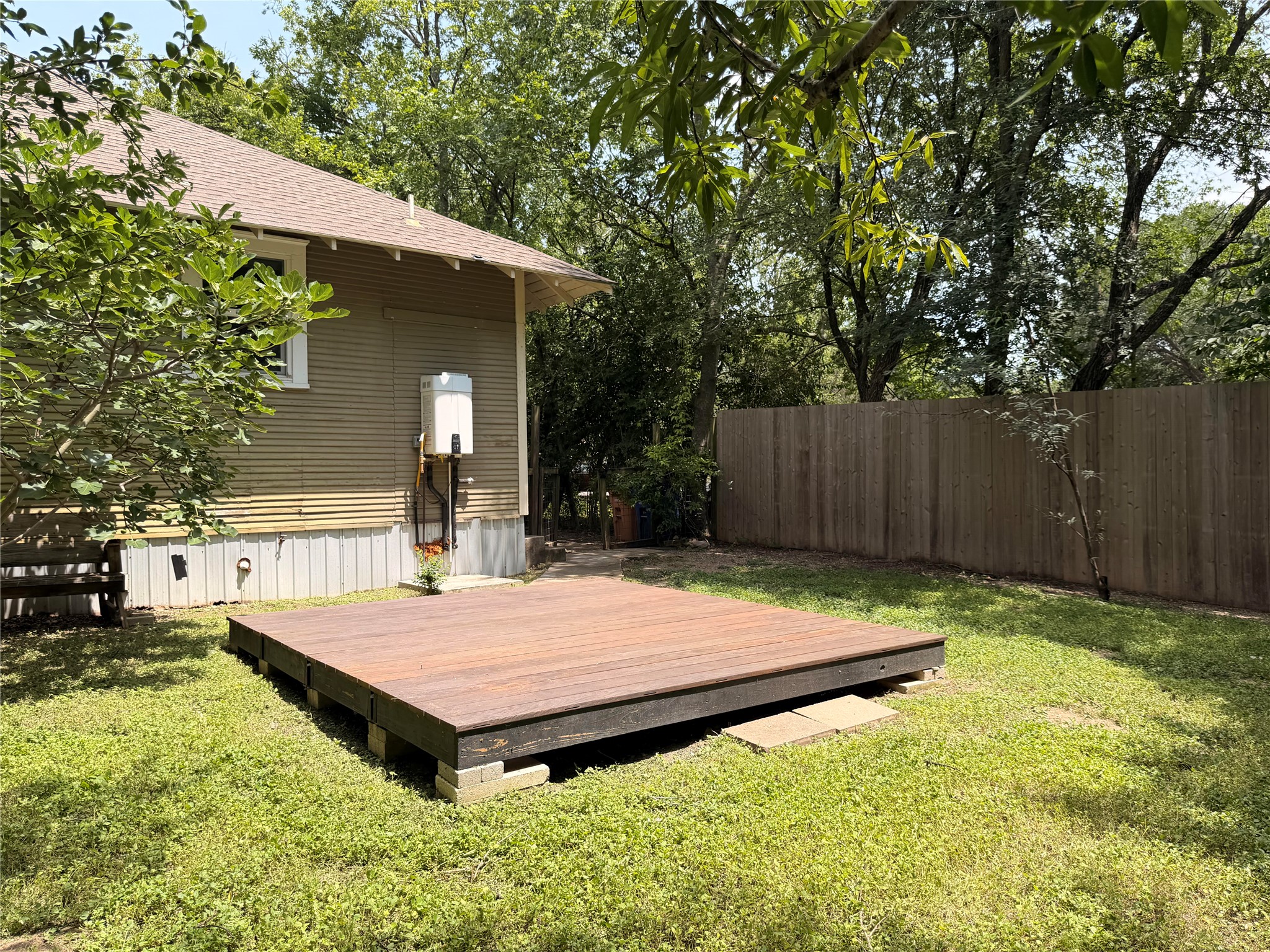 1136 Eleanor Street Austin, TX 78721 - Photo 26 of 30 A private backyard oasis features a spacious deck and verdant surroundings, perfect for outdoor enjoyment.