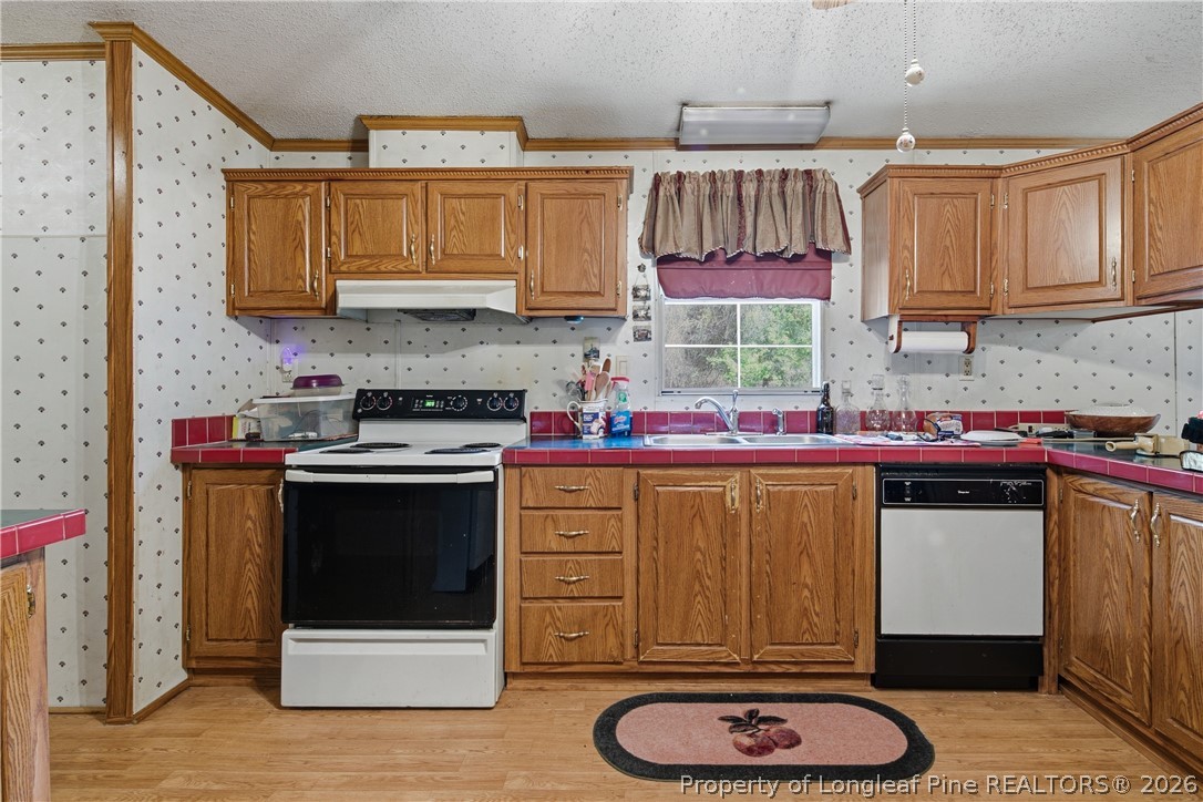 7307 Roslin Farm Road Hope Mills, NC 28348 - Photo 18 of 46 a kitchen with stainless steel appliances granite countertop a stove a sink and a microwave