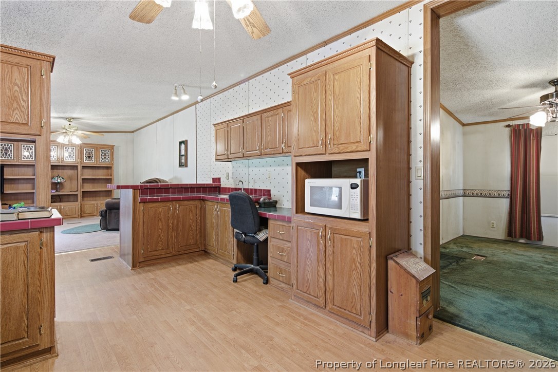7307 Roslin Farm Road Hope Mills, NC 28348 - Photo 19 of 46 a view of kitchen with stainless steel appliances wooden floor and chair