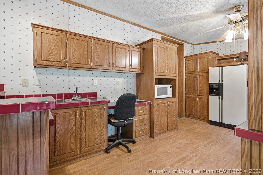 7307 Roslin Farm Road Hope Mills, NC 28348 - Photo 20 of 46 a kitchen with a refrigerator and cabinets