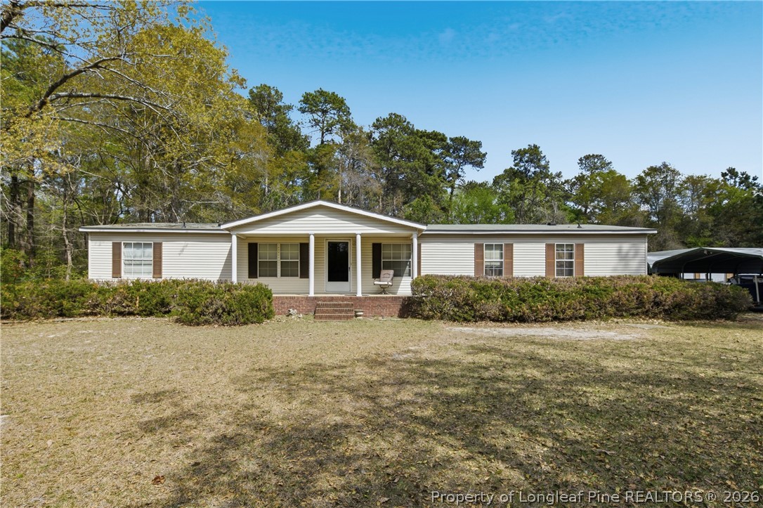 7307 Roslin Farm Road Hope Mills, NC 28348 - Photo 2 of 46 a front view of a house with a yard