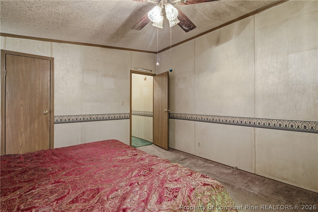 7307 Roslin Farm Road Hope Mills, NC 28348 - Photo 27 of 46 a view of a room with a bed and wooden floor