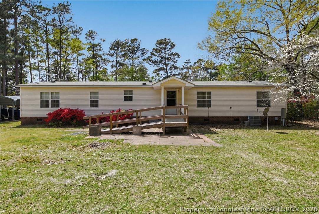 7307 Roslin Farm Road Hope Mills, NC 28348 - Photo 34 of 46 a view of a house with a backyard and a tree