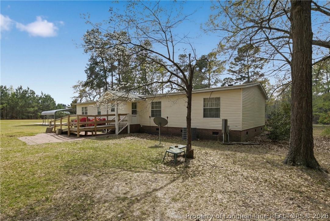 7307 Roslin Farm Road Hope Mills, NC 28348 - Photo 35 of 46 a view of a house with a yard and sitting area