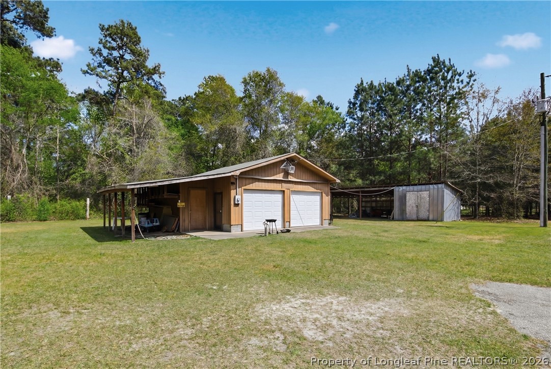 7307 Roslin Farm Road Hope Mills, NC 28348 - Photo 37 of 46 a big house with a big yard and large trees