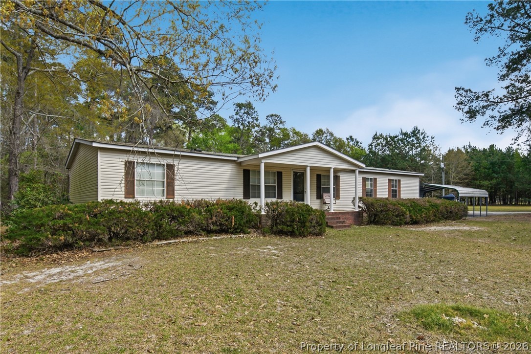 7307 Roslin Farm Road Hope Mills, NC 28348 - Photo 4 of 46 a front view of a house with a yard