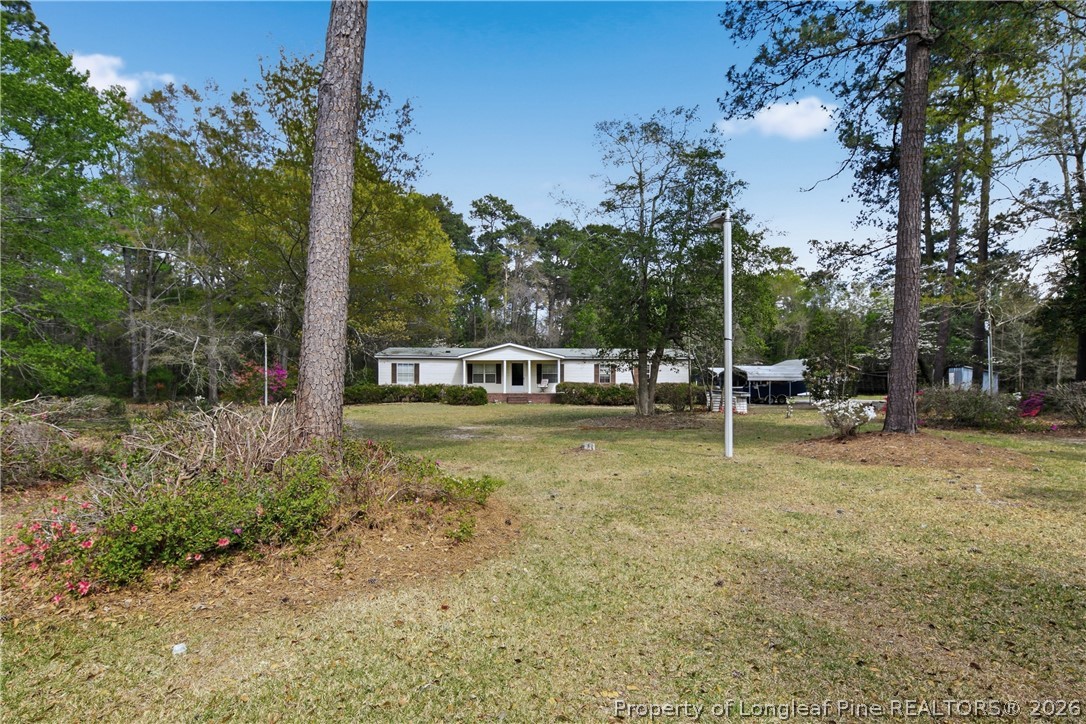 7307 Roslin Farm Road Hope Mills, NC 28348 - Photo 6 of 46 a view of a house with a yard