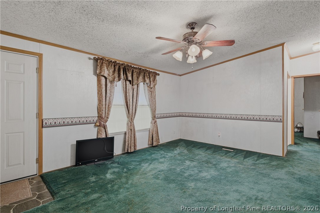 7307 Roslin Farm Road Hope Mills, NC 28348 - Photo 10 of 46 an empty room with windows and fan