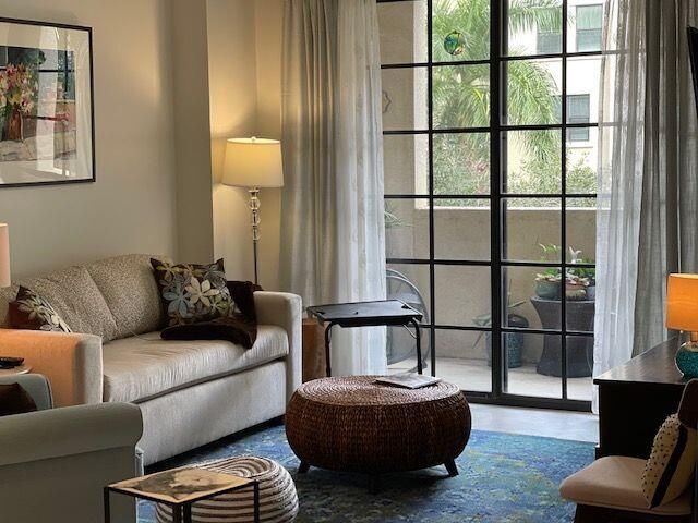 233 South Federal Highway, Unit 301 Boca Raton, FL 33432 - Photo 1 of 30 a living room with furniture a rug and a window