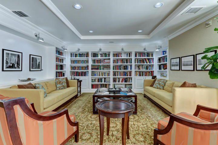 233 South Federal Highway, Unit 301 Boca Raton, FL 33432 - Photo 16 of 30 a living room with furniture a rug and a bookshelf