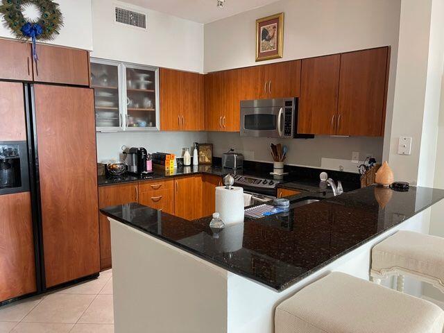 233 South Federal Highway, Unit 301 Boca Raton, FL 33432 - Photo 7 of 30 a kitchen with stainless steel appliances granite countertop a sink refrigerator and stove