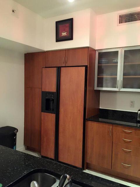 233 South Federal Highway, Unit 301 Boca Raton, FL 33432 - Photo 8 of 30 a kitchen with a refrigerator and cabinets