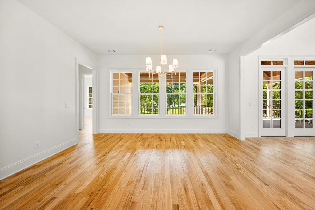 707 Vickery Street Extension Hartwell, GA 30643 - Photo 13 of 50 Hardwood floors and natural light from large windows highlight this spacious dining room.
