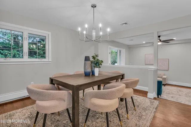 a view of a dining room with furniture and wooden floor
