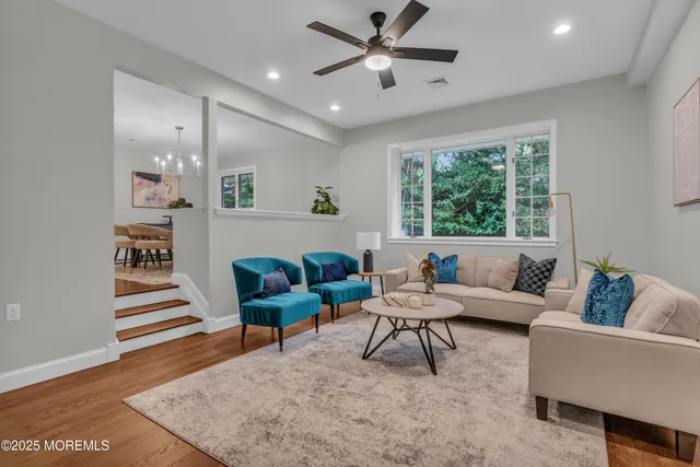 a living room with furniture and a wooden floor