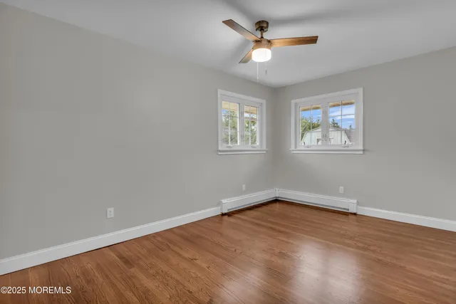 wooden floor in an empty room with a window