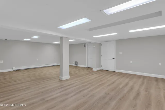 a view of an empty room with wooden floor