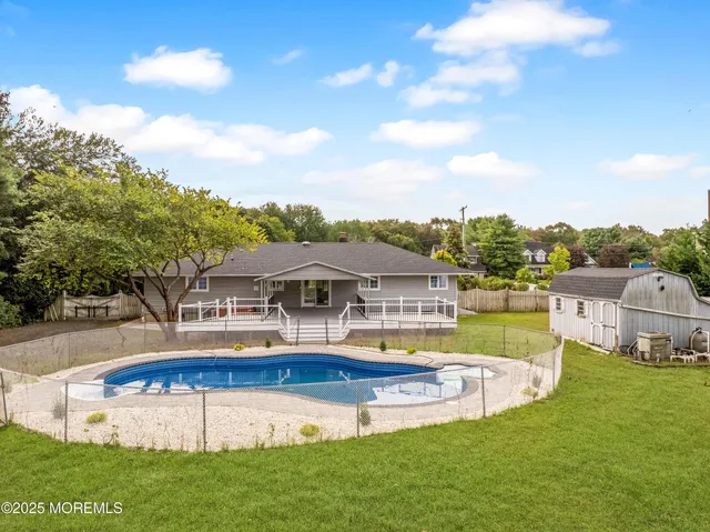 a view of a house with a big yard and large trees
