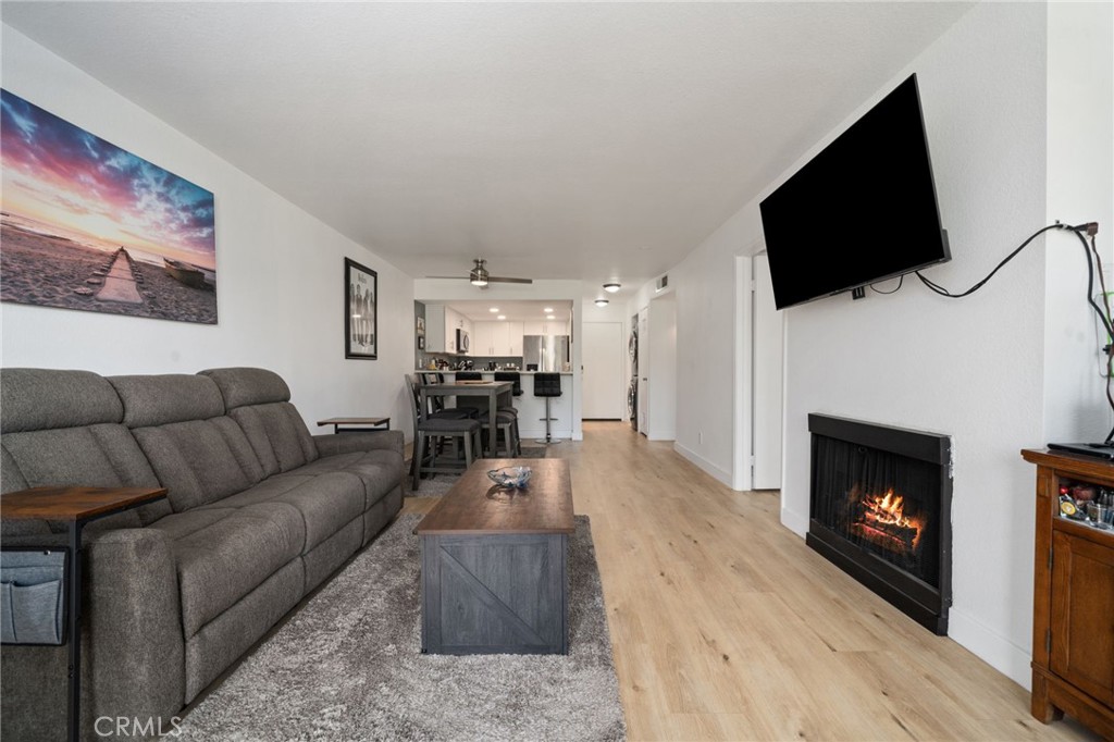1237 East 6th Street, Unit 201 Long Beach, CA 90802 - Photo 11 of 27 a living room with furniture a flat screen tv and a fireplace