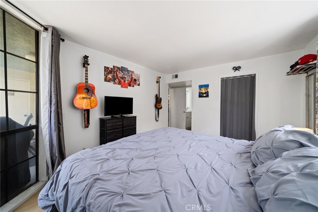 1237 East 6th Street, Unit 201 Long Beach, CA 90802 - Photo 13 of 27 a bedroom with bed and a tv on the dresser