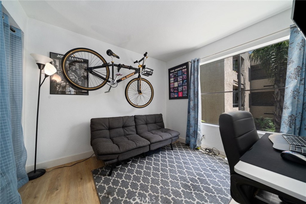 1237 East 6th Street, Unit 201 Long Beach, CA 90802 - Photo 17 of 27 a living room with furniture a rug a window and a wooden floor