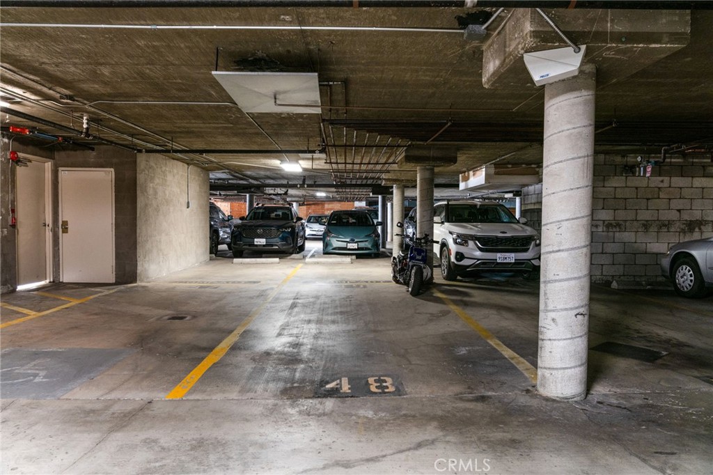 1237 East 6th Street, Unit 201 Long Beach, CA 90802 - Photo 22 of 27 a view of parking garage with cars