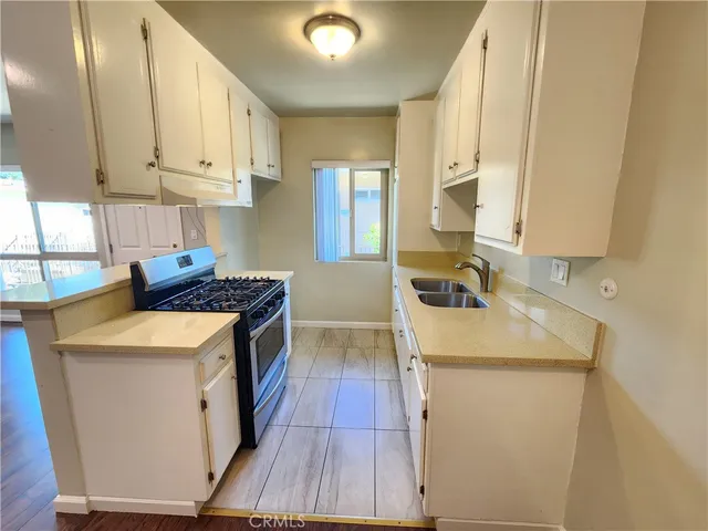 a kitchen that has a sink and a stove in it
