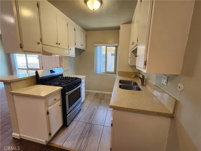 a kitchen that has a sink and a stove