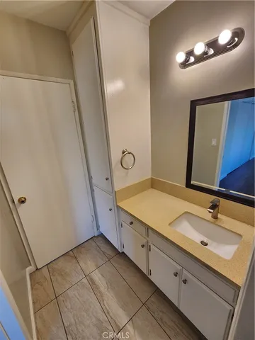 a bathroom with a double vanity sink and a mirror