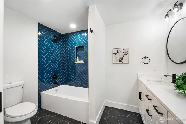 a bathroom with a granite countertop double vanity sink and a mirror