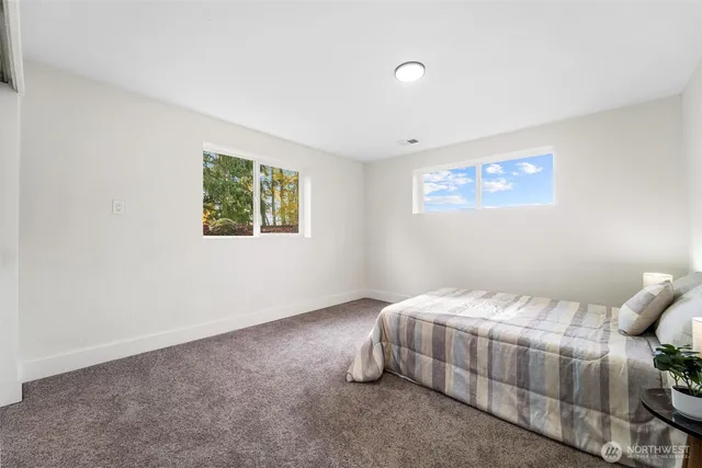 a bedroom with a bed and a painting on the wall