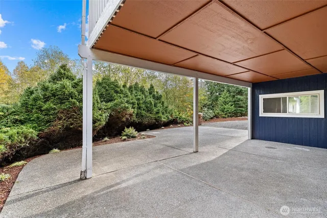 a view of a house with a yard and potted plants