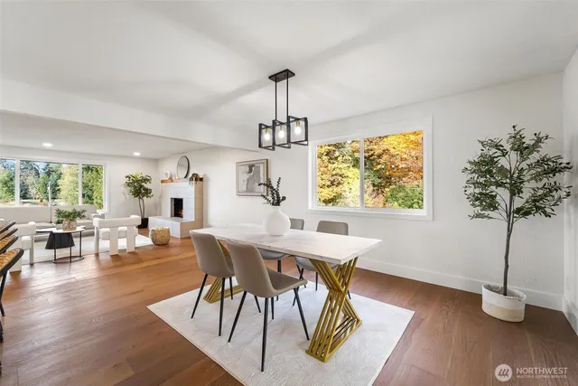 a large kitchen with stainless steel appliances kitchen island granite countertop a stove a sink and a microwave