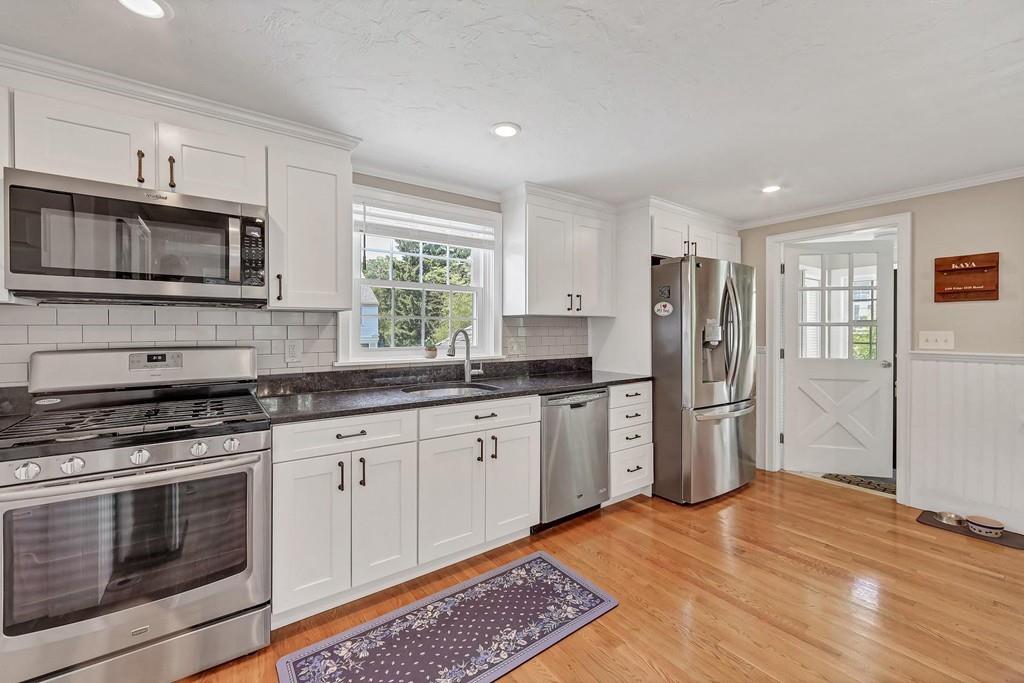 150 Edge Hill Road Milton, MA 02186 - Photo 5 of 22 a kitchen with stainless steel appliances granite countertop a stove a sink and a refrigerator