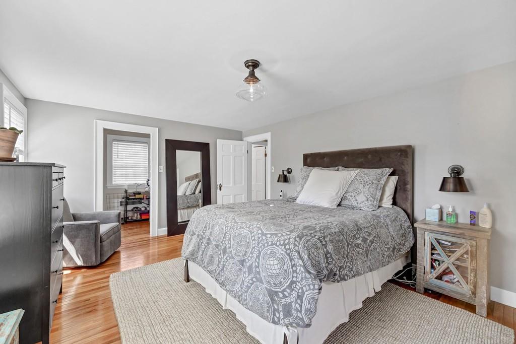 150 Edge Hill Road Milton, MA 02186 - Photo 8 of 22 a bedroom with a large bed couch and a window