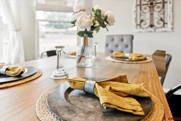 a dining room with furniture and wooden floor